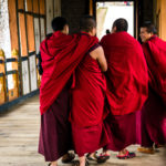 Monks crossing the bridge in Punakha Dzong, Bhutan