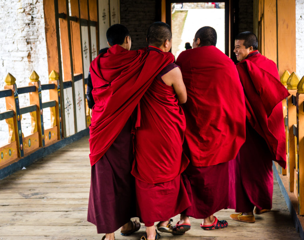 Monks crossing the bridge in Punakha Dzong, Bhutan