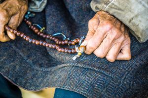 Man holding prayer beads in Punakha, Bhutan
