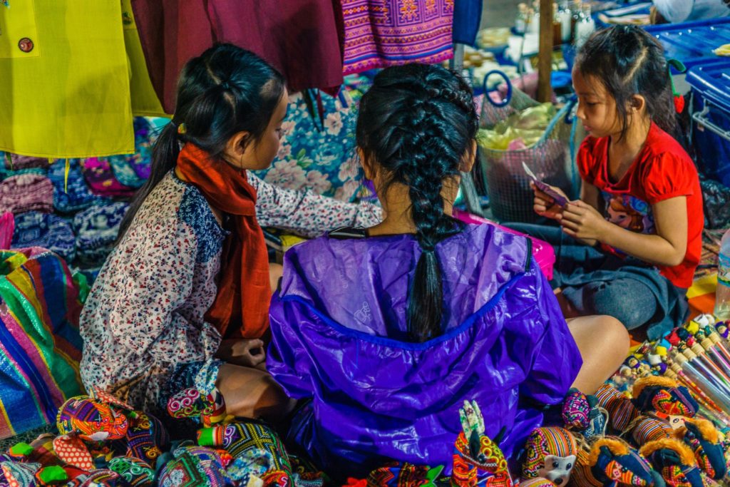 Girls playing card games, Luang Prabang night market
